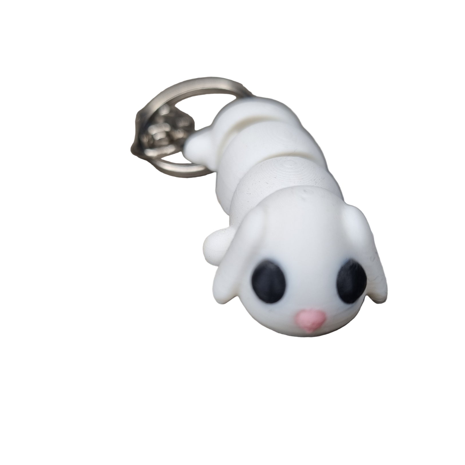 White flexi rabbit keychain with black eyes and pink nose on a wooden surface